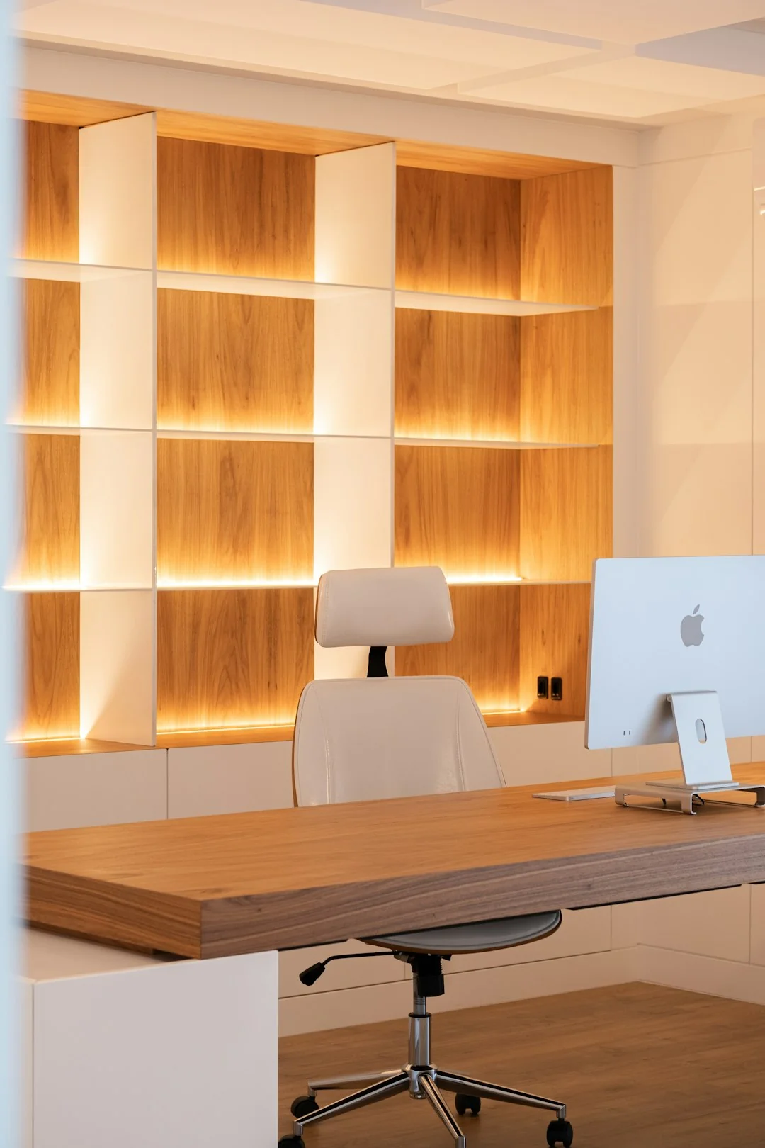 Spacious and contemporary office interior with glass partitions, stylish furniture, and vibrant wall art.